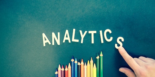 Law firm online marketing: Hand pointing the word Analytics on table on a board.